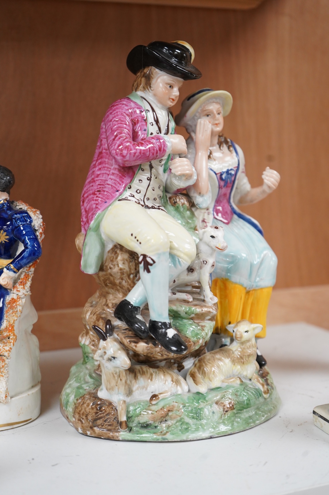 A Ralph Wood style group and three Staffordshire figures, largest 26cm high